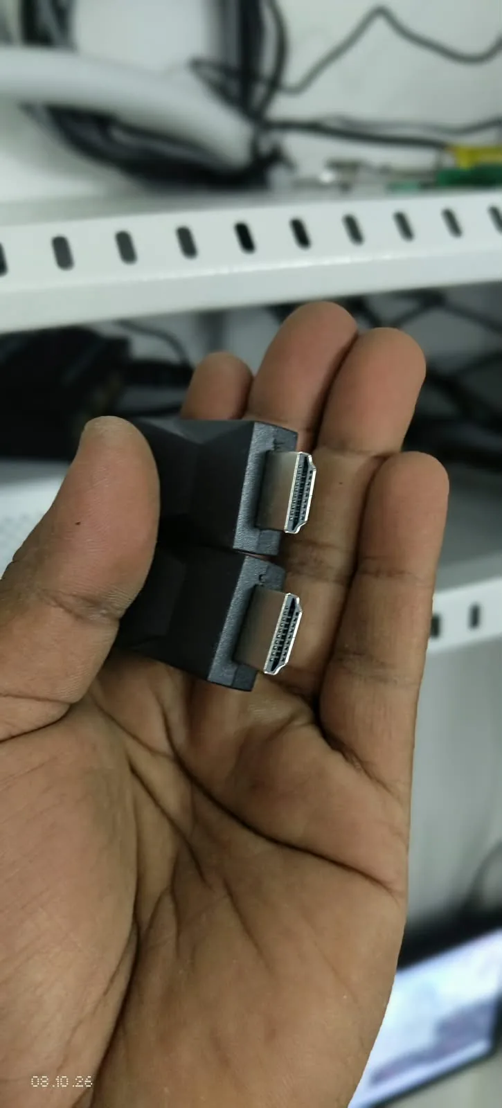 Two black HDMI connection accessories with visible HDMI plugs