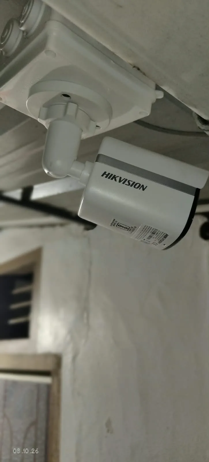Hikvision bullet camera mounted below a ceiling junction box