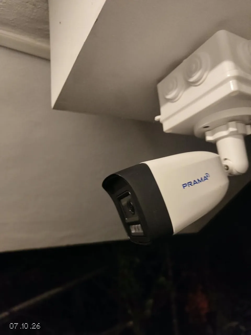 PRAMA bullet camera mounted beneath the ceiling beside a junction box