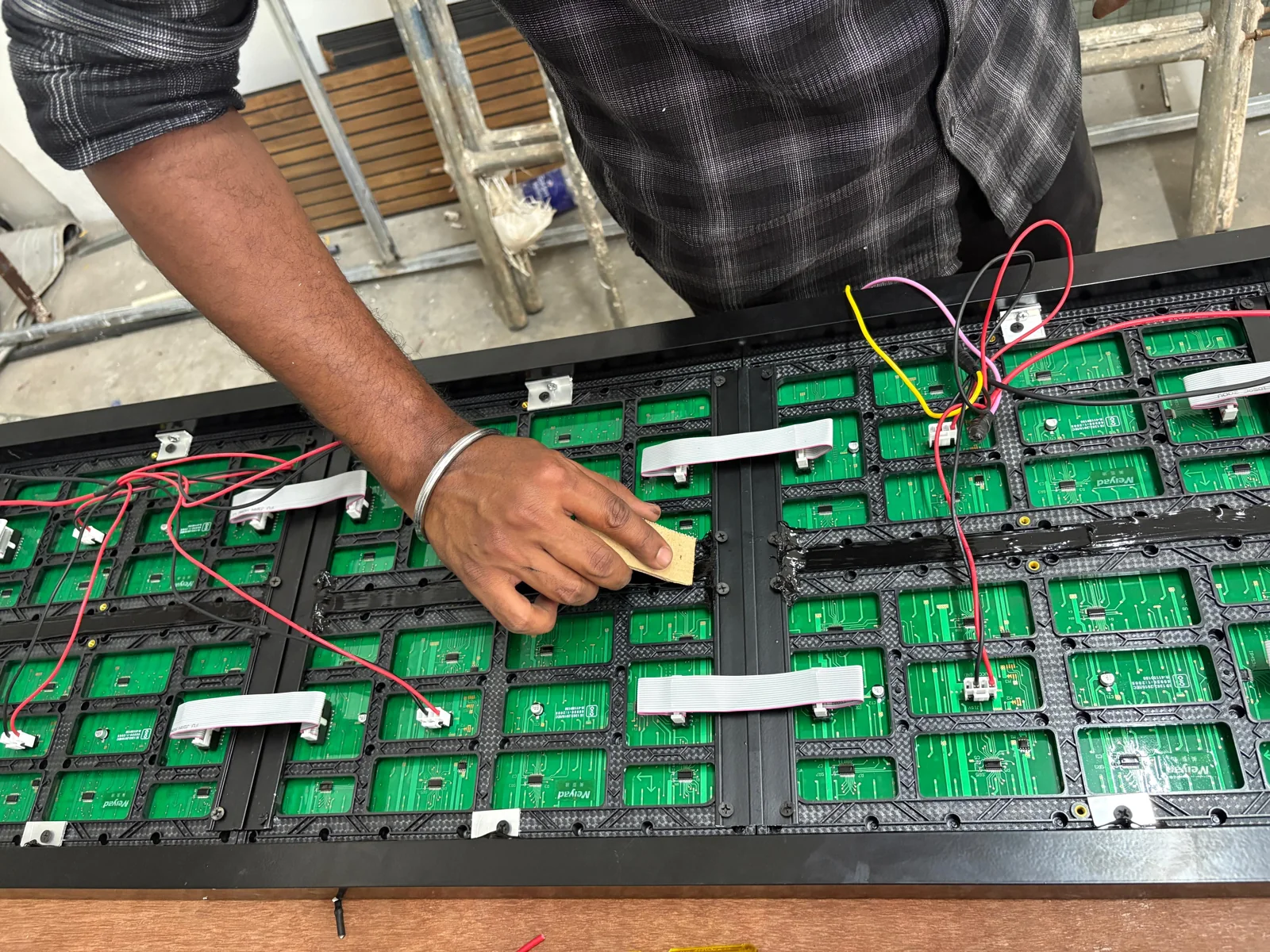 Rear of P10 LED modules with power wires, ribbon cables and silicone sealing during assembly at Halo Technologies